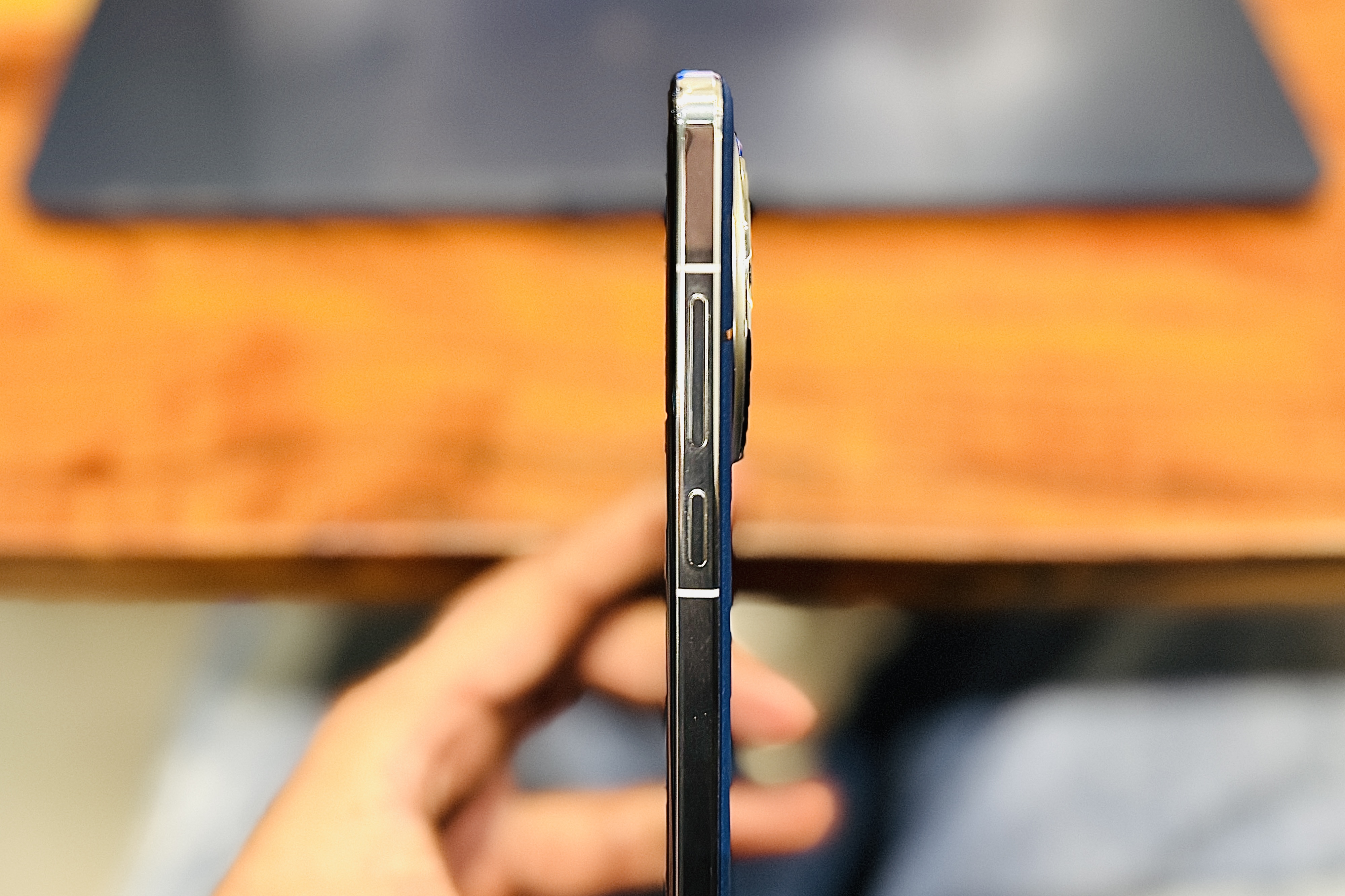 Side profile of the OnePlus 13 held in a person