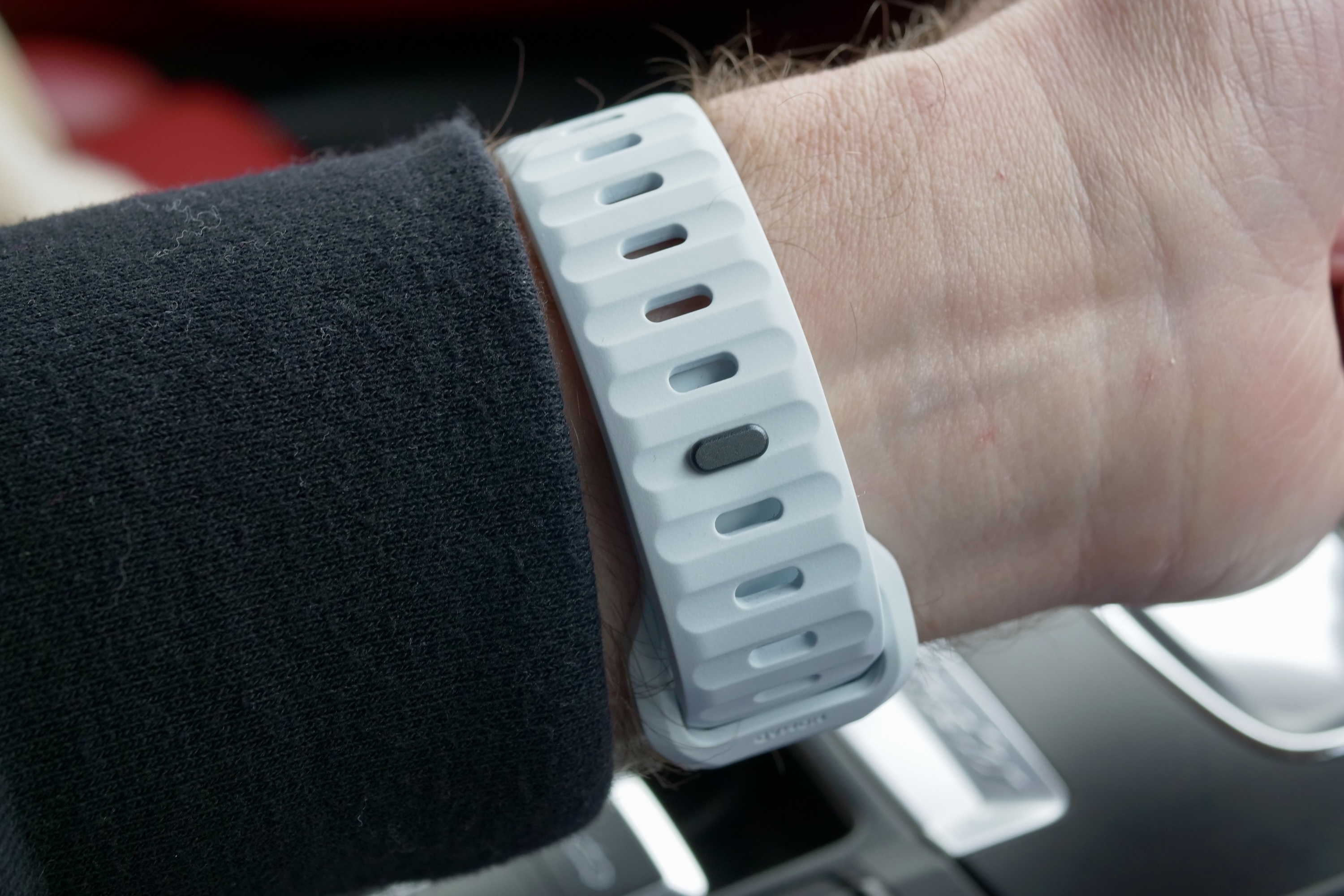 A person wearing the Nomad Sport Band in the Icy Blue glow-in-the-dark finish.