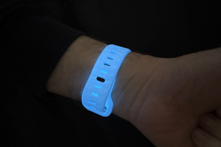 A person wearing the Nomad Sport Band in the Icy Blue glow-in-the-dark finish.