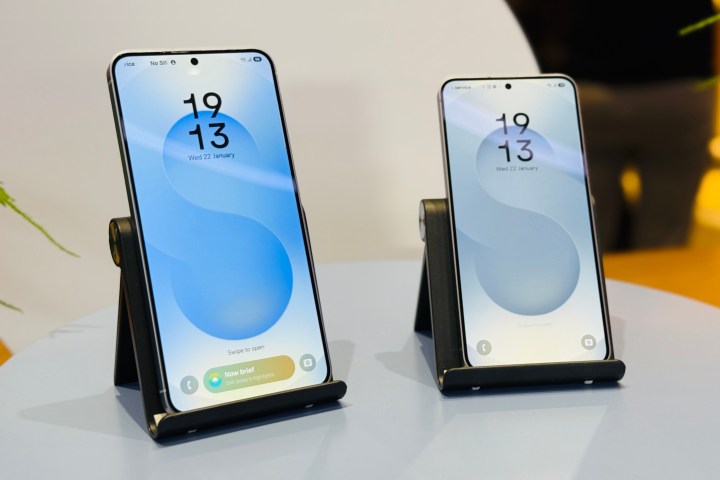 The Samsung Galaxy S25 and Galaxy S25 Plus on a stand.