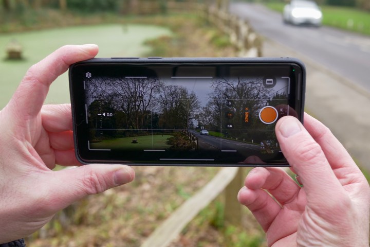 A person using the XPan mode on the OnePlus 13.