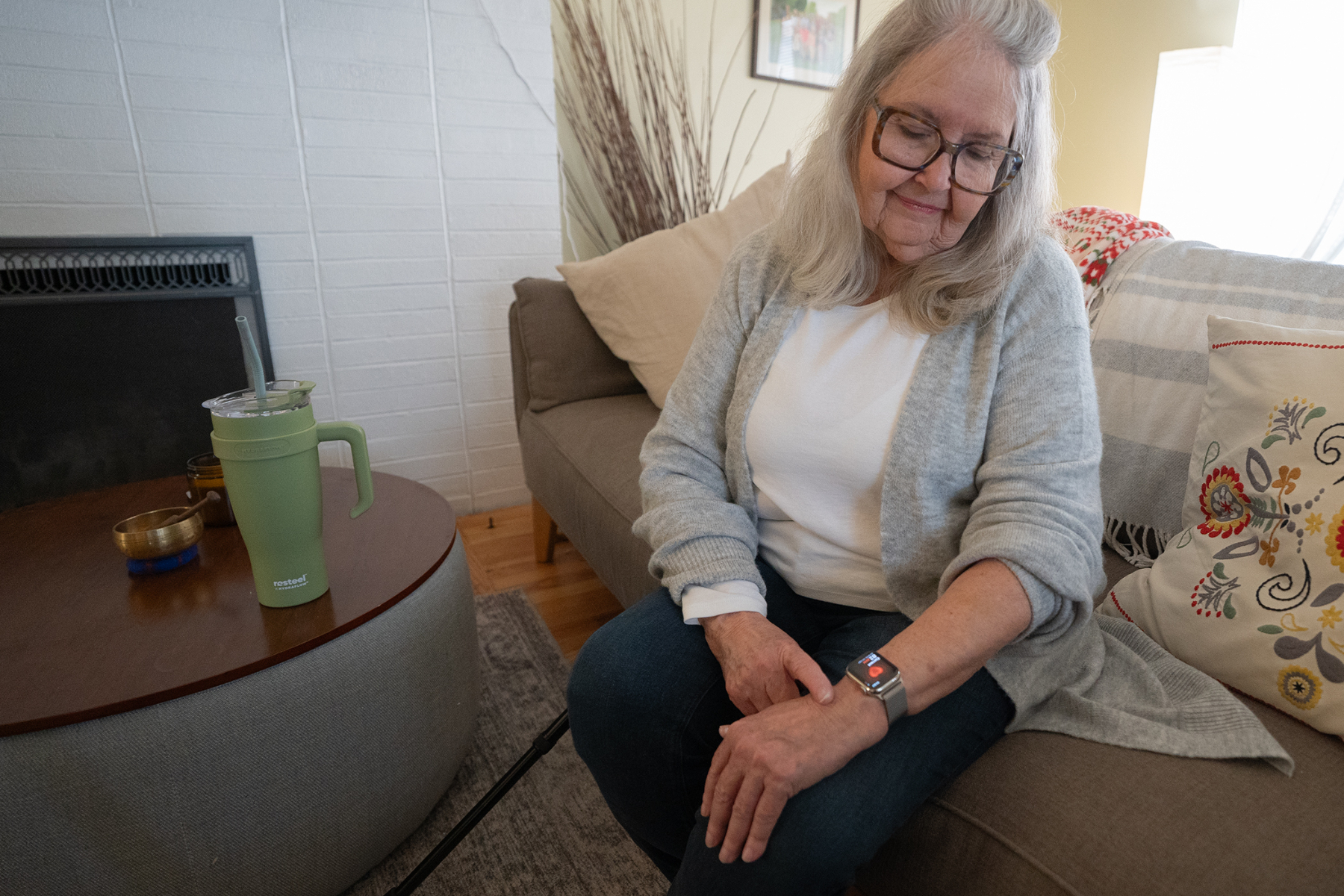 An older woman checking her smartwatch.