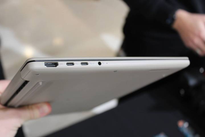 Image of the Asus Zenbook A14 being held, showcasing its lightweight design.