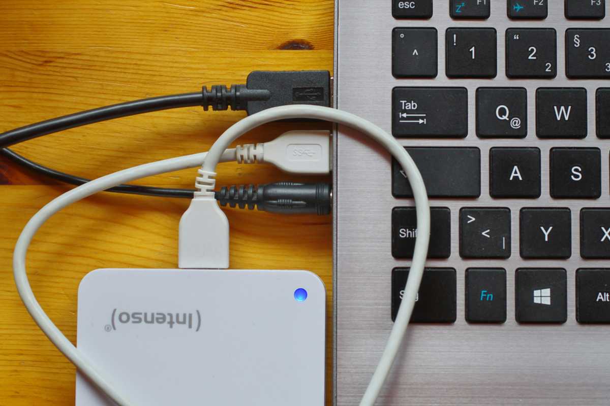 An external hard drive connected to a laptop.