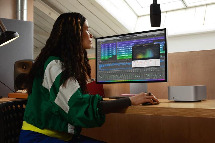 A person using a Mac Studio with an Apple Studio Display.