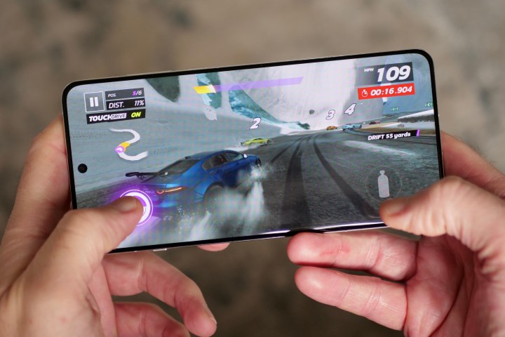 A person playing a game on the OnePlus 13.