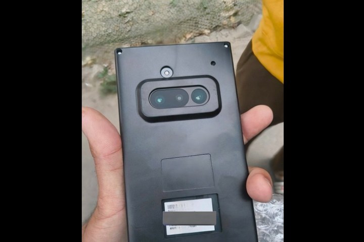 Alt text: A close-up image of the purported Nothing Phone 3a encased in a protective plastic covering, hinting at a triple-camera system.