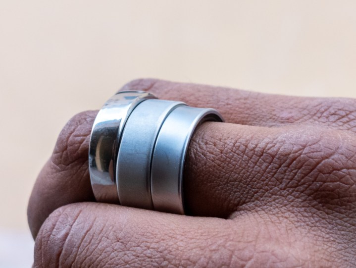 Alt: The Oura Ring 4, Galaxy Ring, and RingConn Gen 2 worn on the same finger to compare sizes and designs.