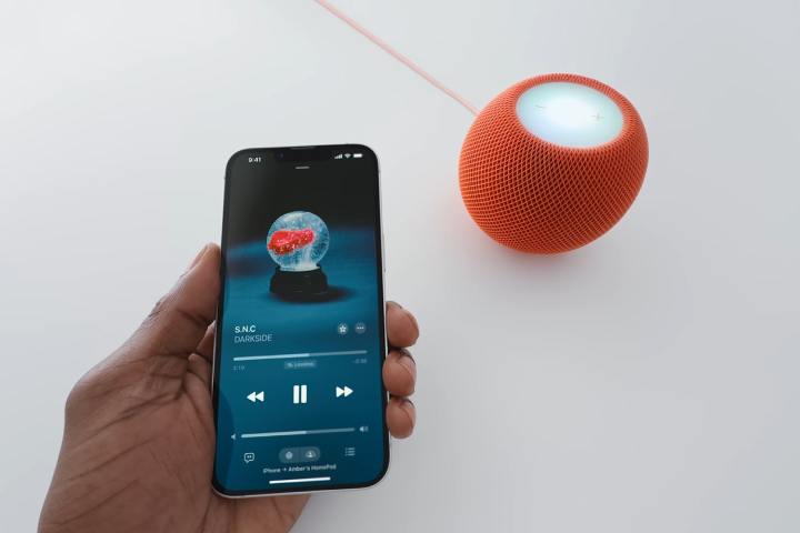 Alt text: iPhone 16e being used near a HomePod mini.