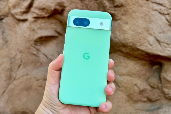 Alt text: A person holding a Google Pixel 8a smartphone.