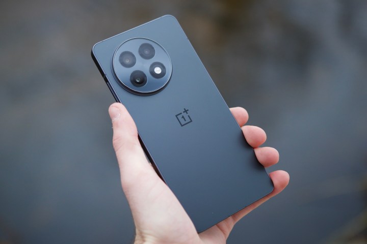 Holding OnePlus 13R showing back of the phone