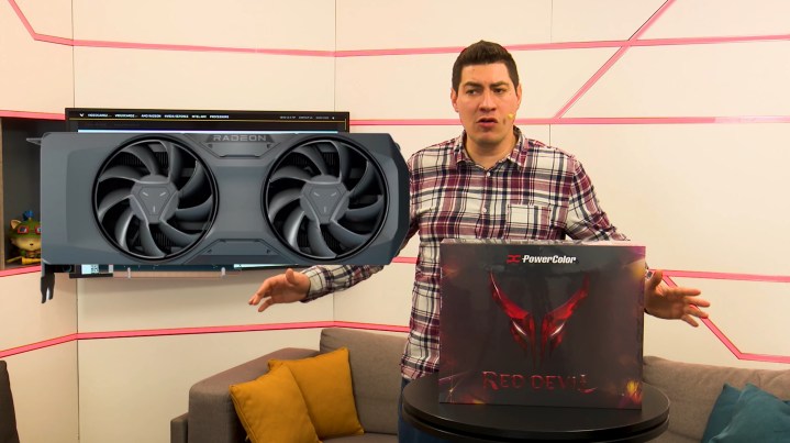 A man showcases the RX 9070 XT PowerColor Red Devil box.