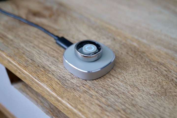 alt: The RingConn Gen 2 Air smart ring on its charging puck.