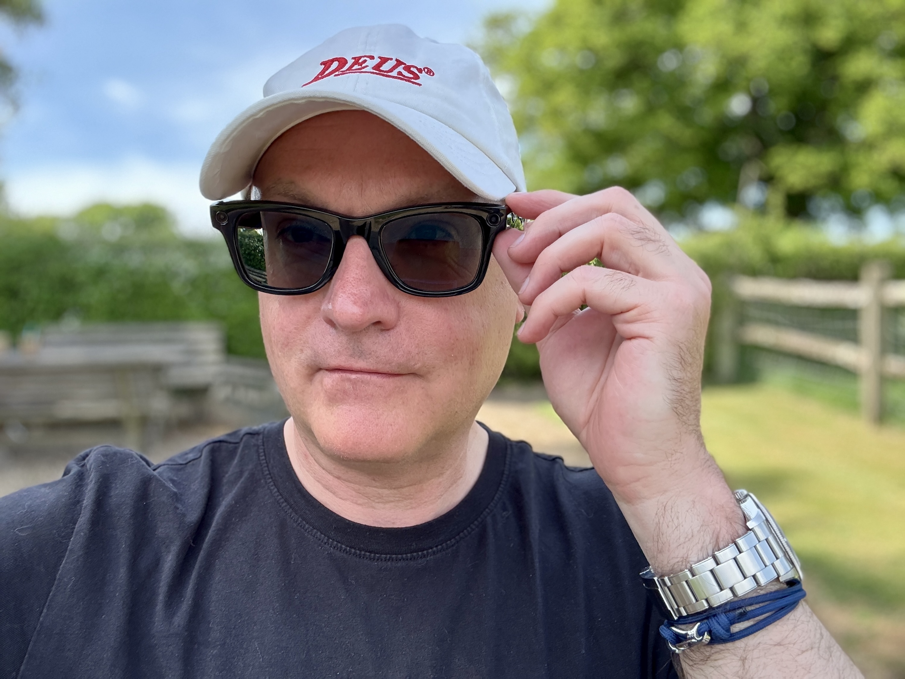 alt text: A person wearing Ray-Ban Meta smartglasses while driving.