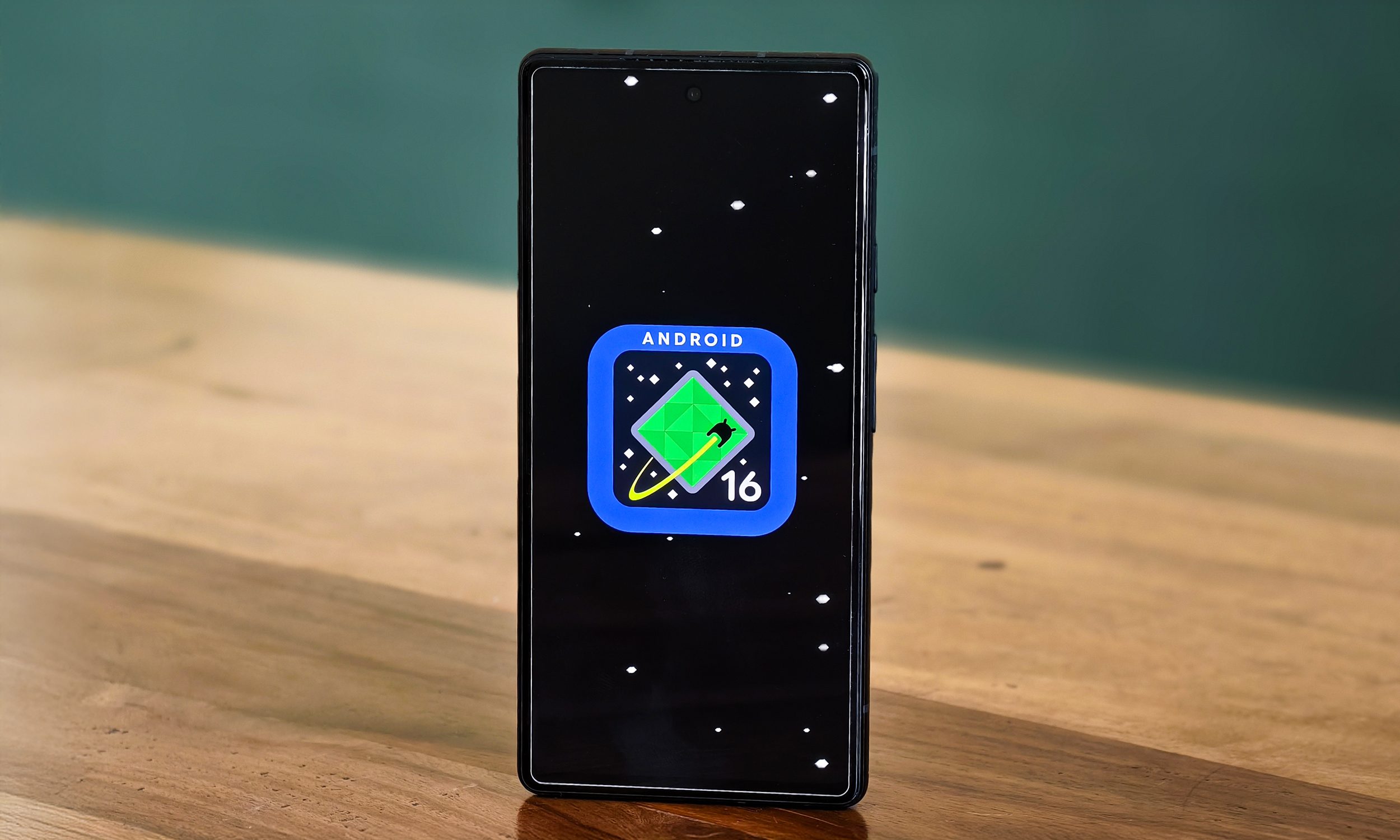 alt: A Google Pixel 6a displaying the Android 16 logo.