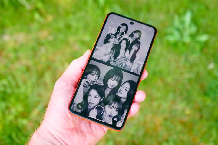 A person holding the CMF Phone 2 Pro showing the lock screen.