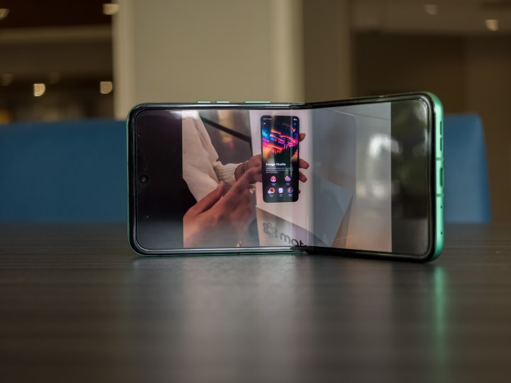 alt: The Motorola Razr 2025 partially unfolded, playing a YouTube video on the main display.