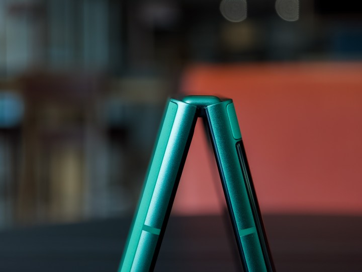 alt: Side view of the partially open Motorola Razr 2025, showcasing the hinge mechanism and Spring Bud green color.