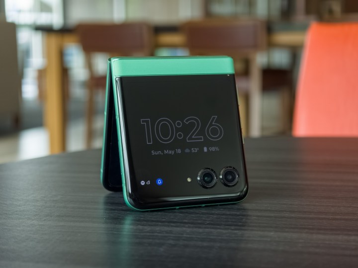 alt: The Motorola Razr 2025 in Spring Bud green, partially open with the cover display turned off.
