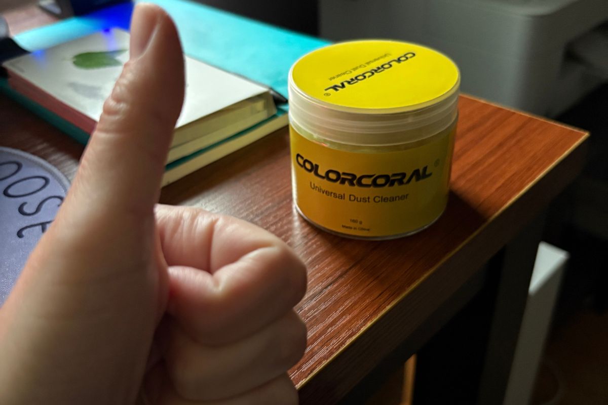 Keyboard cleaning gel stored neatly in its plastic container next to a computer mouse.