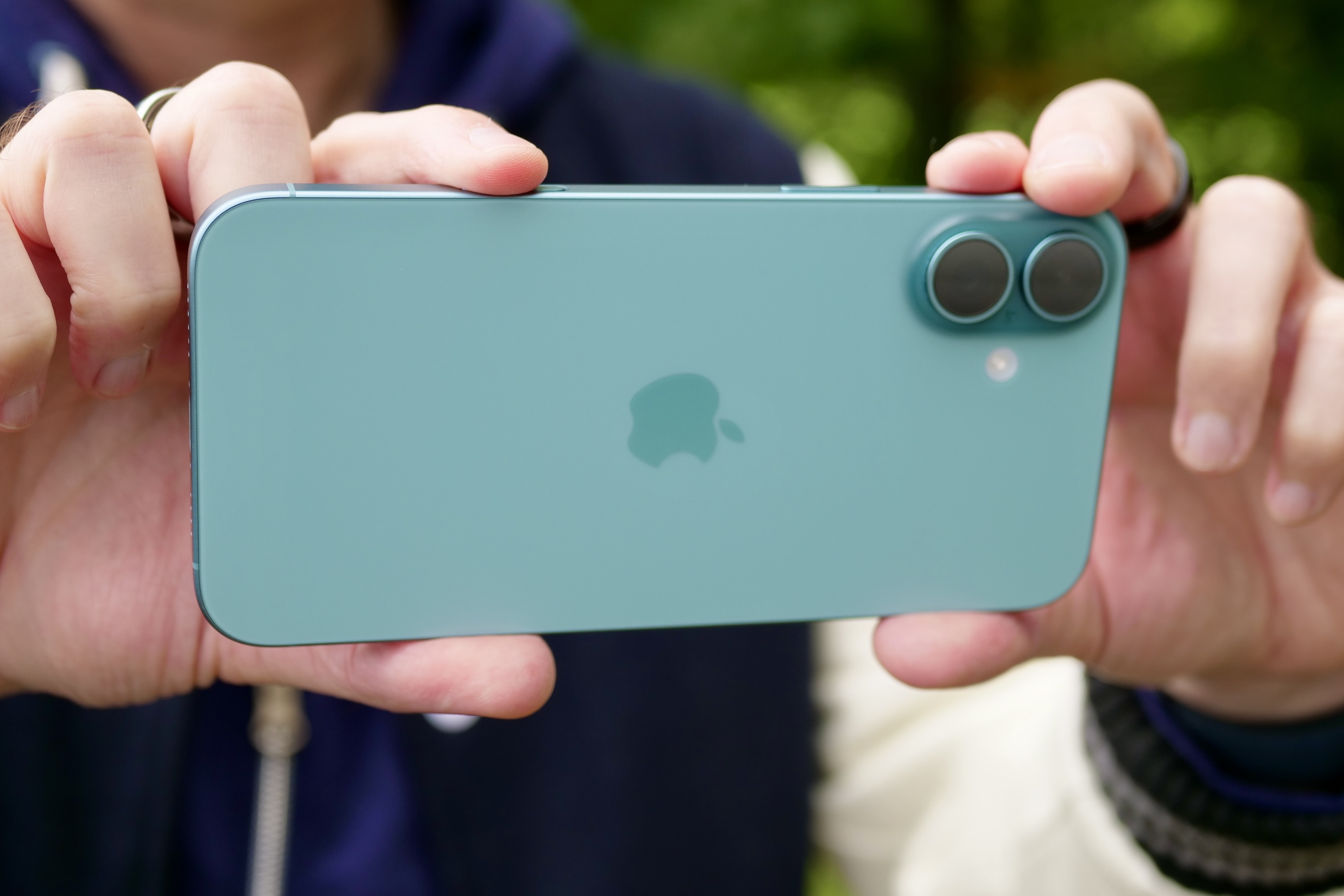 Apple iPhone 16 Plus in use for photography, emphasizing its dual-camera system as an alternative for Motorola Razr 2025 users.