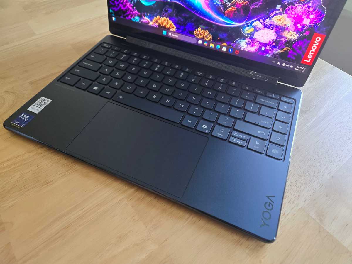 Close-up shot of the Lenovo Yoga 9i 2-in-1 keyboard and large trackpad, highlighting key travel and layout.