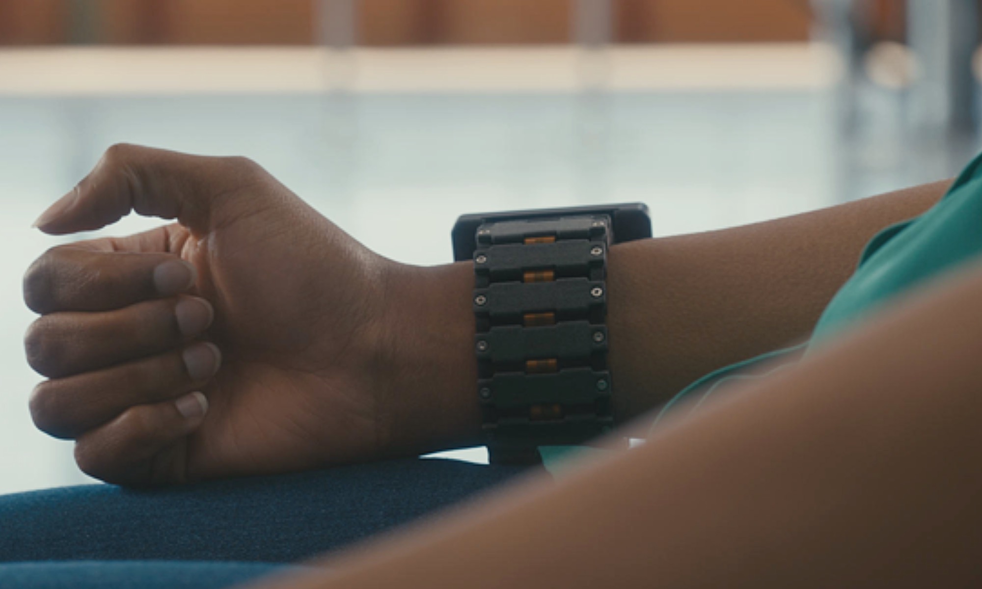 Person wearing Meta's EMG wristband designed for gesture-based device control.
