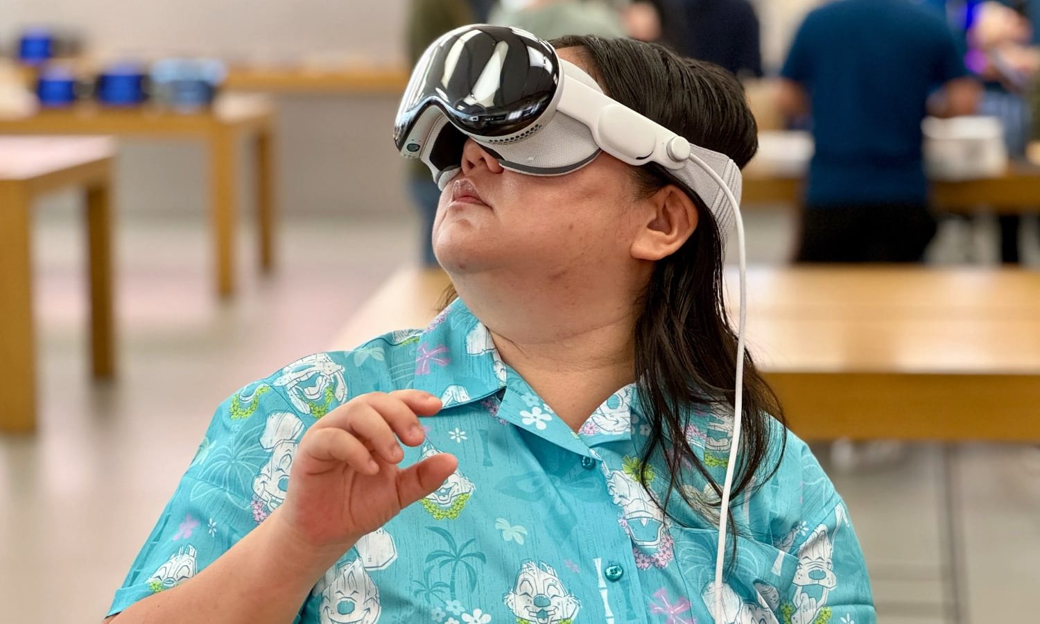 User trying out the Apple Vision Pro headset for an immersive mixed reality experience.