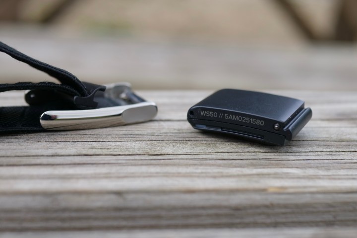 Side profile of the Whoop 5.0 fitness tracker module, showing its thickness and sensor array.