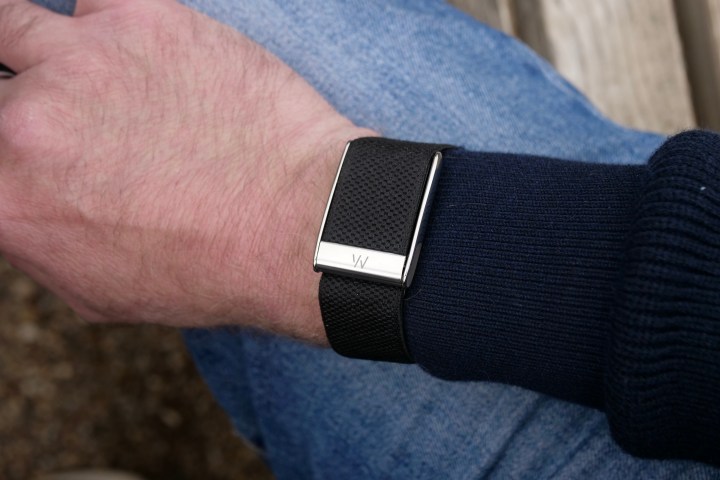 A person's wrist wearing the Whoop 5.0 fitness tracker, showcasing its band and module.