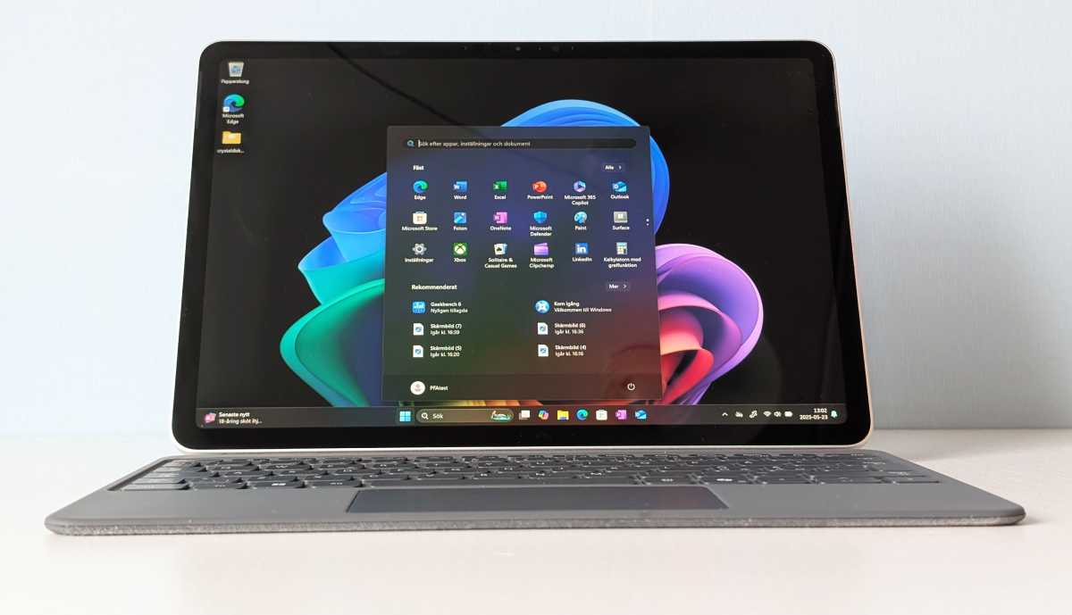 The slim Microsoft Surface Pro 2025 resting on a wooden table, showcasing its compact and portable design.