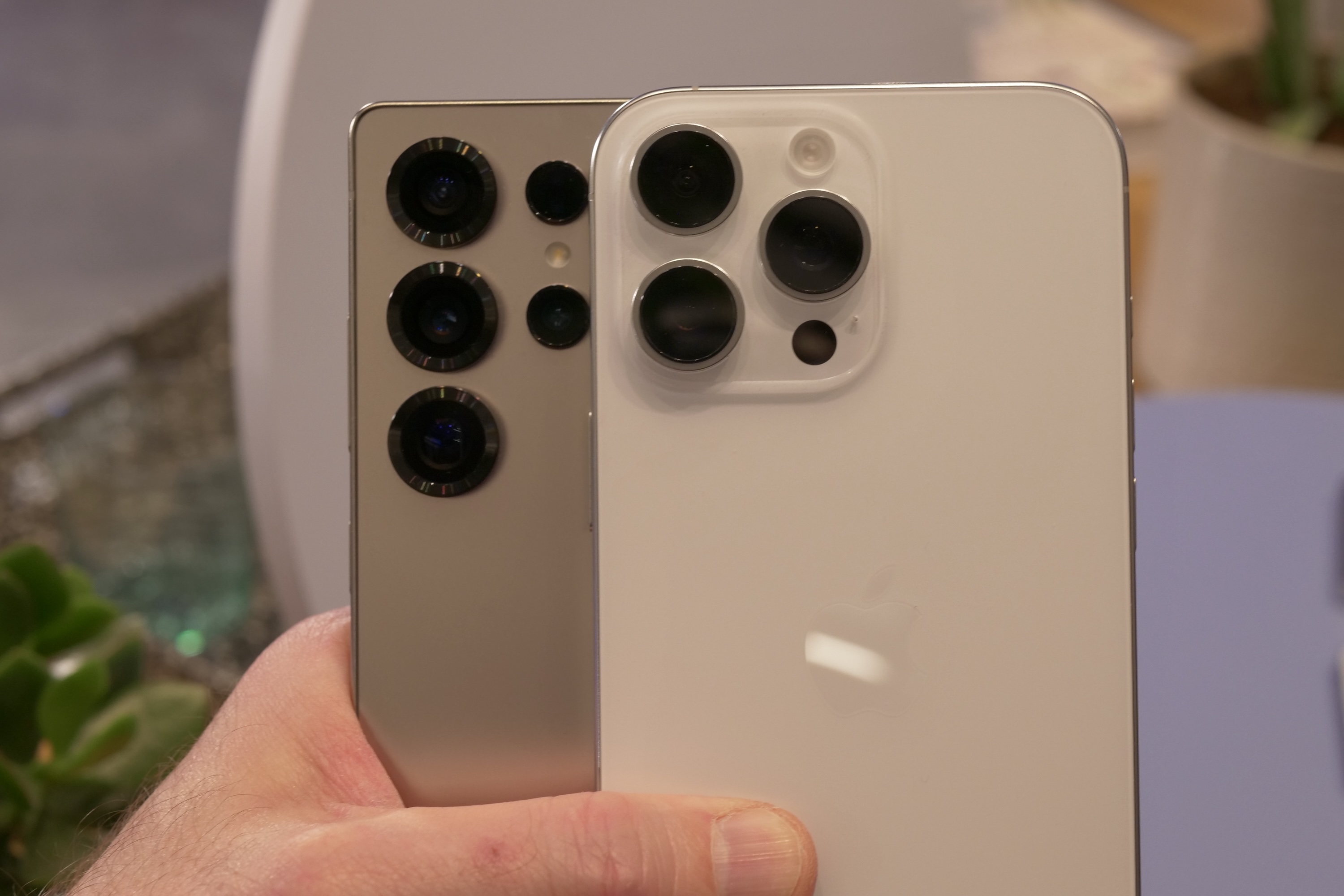 Samsung Galaxy S25 Ultra and Apple iPhone 16 Pro Max side-by-side, back view.