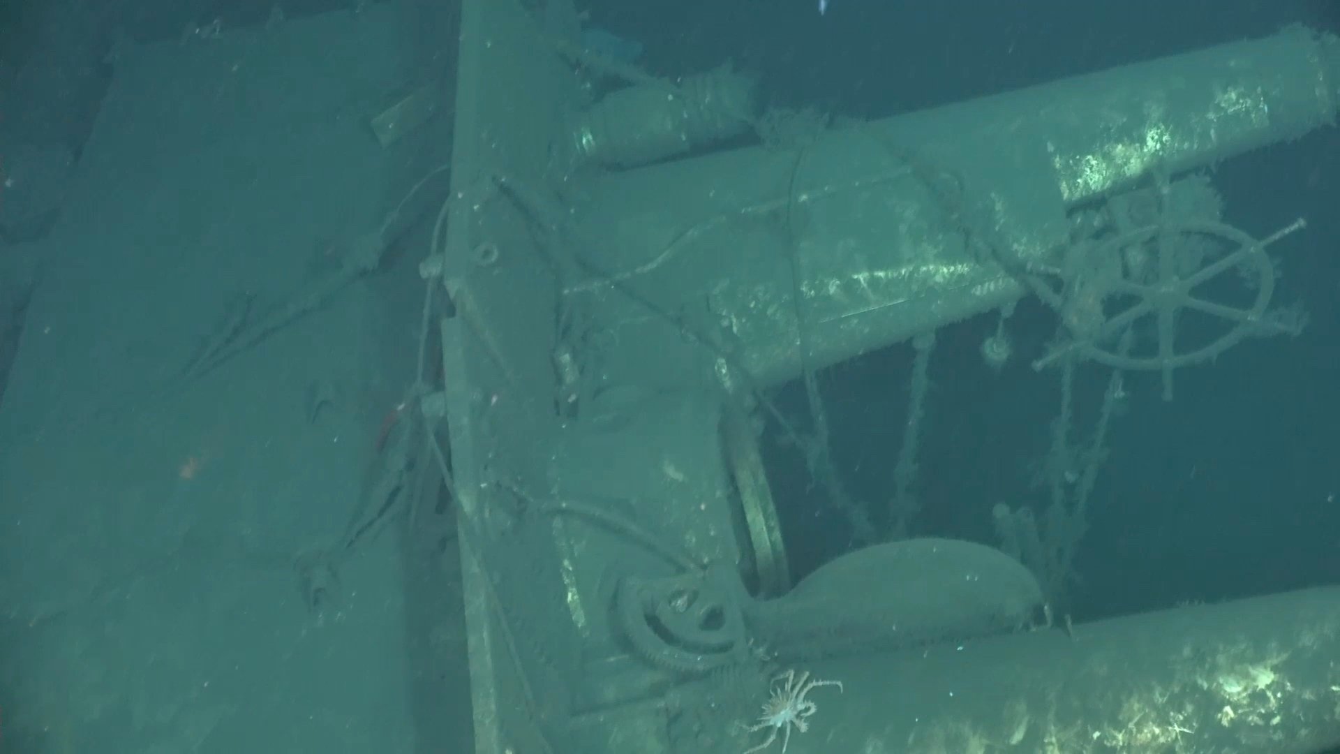 Detailed view of the external ship's wheel on the sail of the sunken USS F-1 submarine, captured by deep-sea imaging.