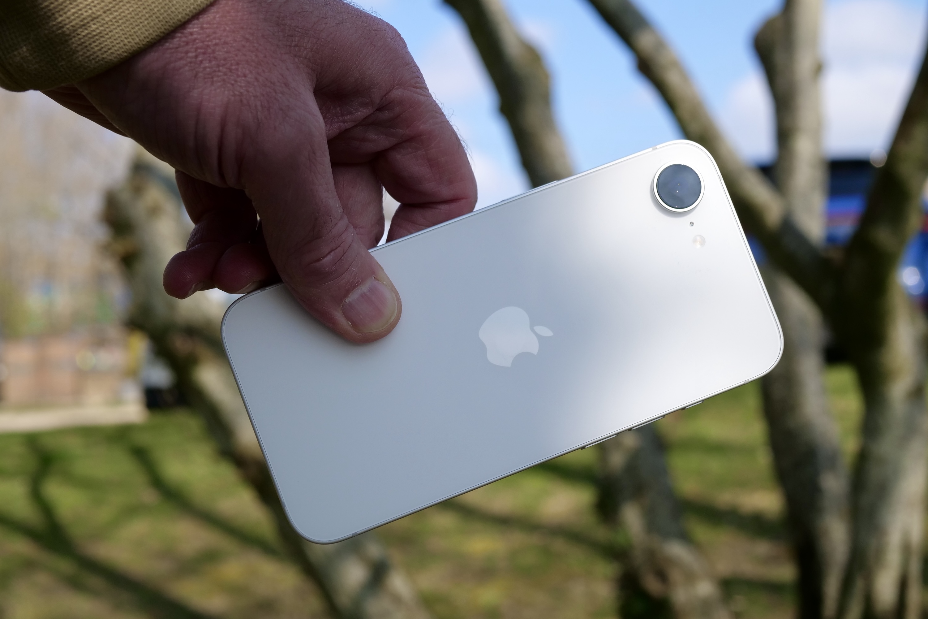 A person holding the Apple iPhone 16e.
