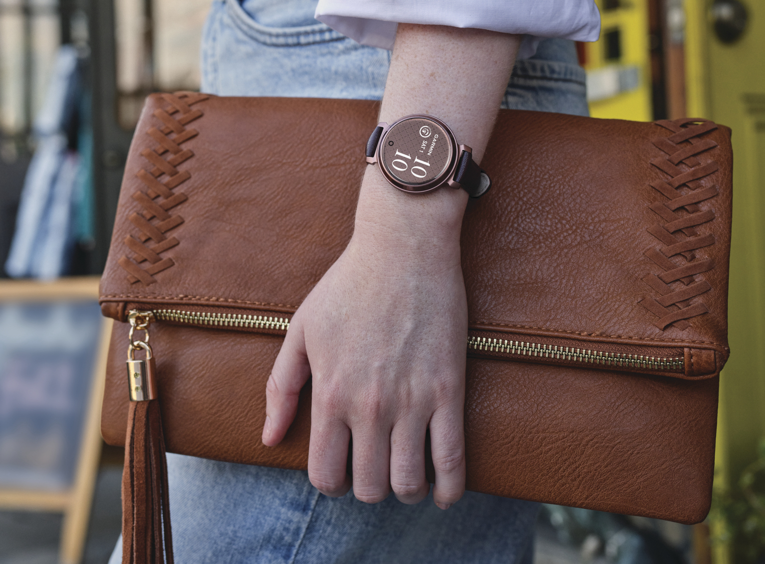 alt: A woman wearing a Garmin Lily 2 smartwatch.