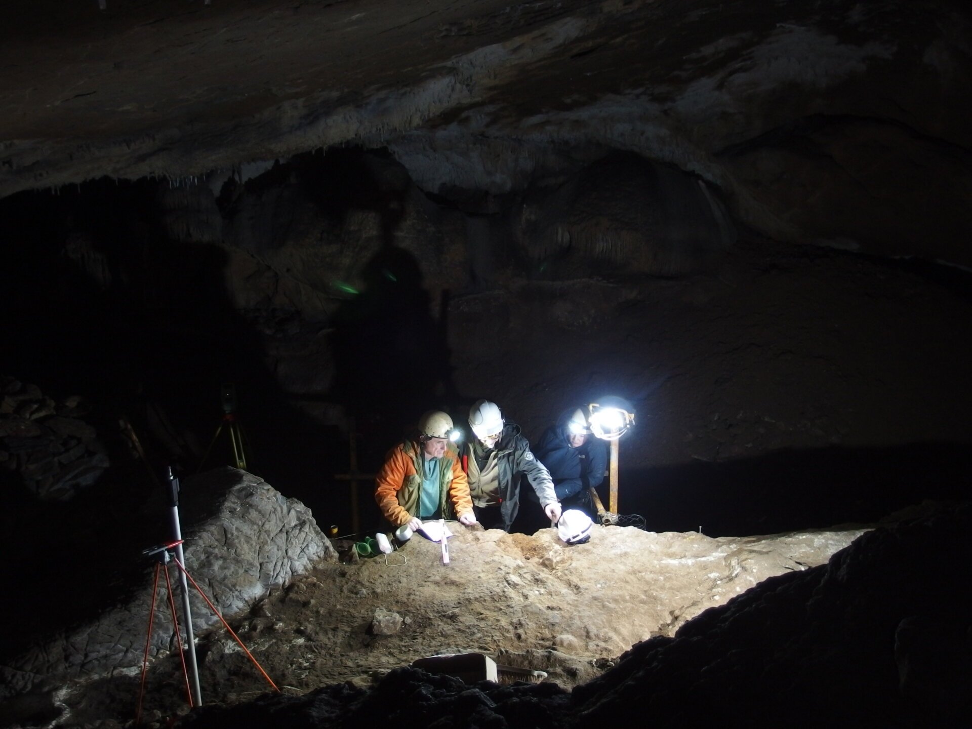 Archaeologists carefully excavating prehistoric whale bone artifacts in a Basque cave, France.