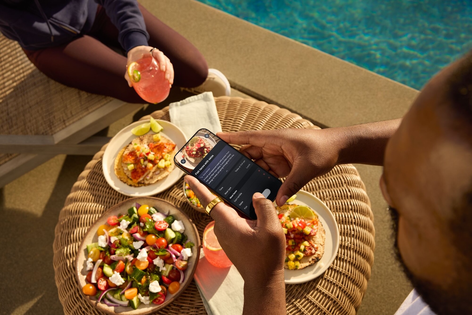 A promotional image for the Oura Ring showing the meal logging feature
