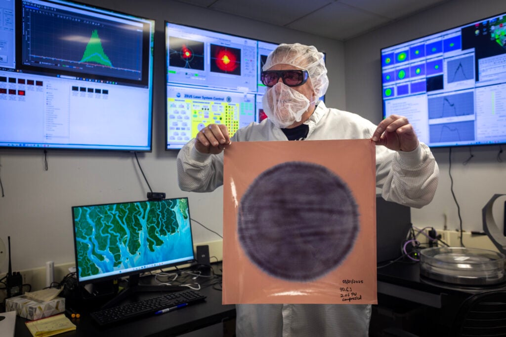 An engineer shows a laser burn mark from the expanded laser pulse.
