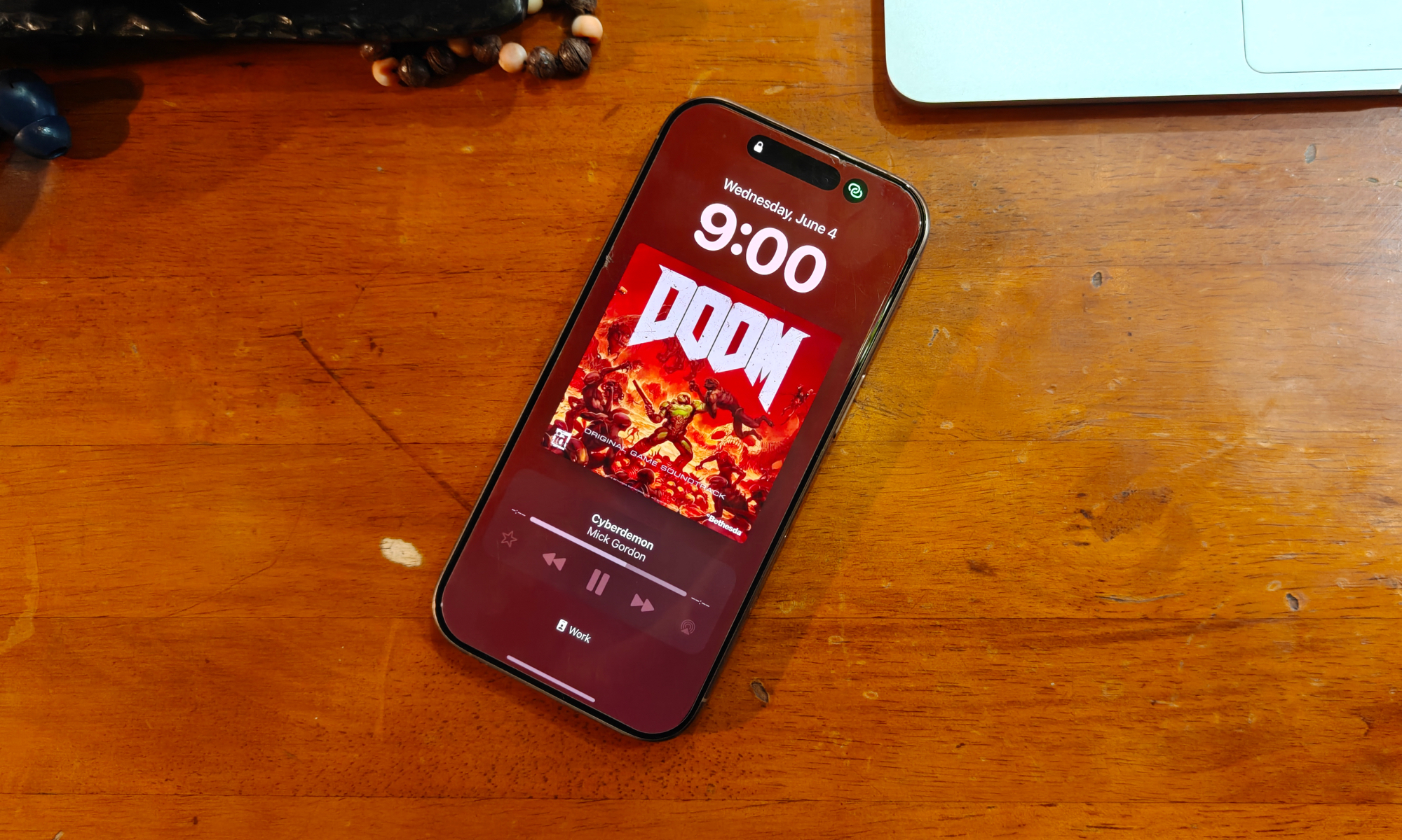 iPhone lock screen showcasing album art, illustrating potential iOS 26 animated artwork feature.