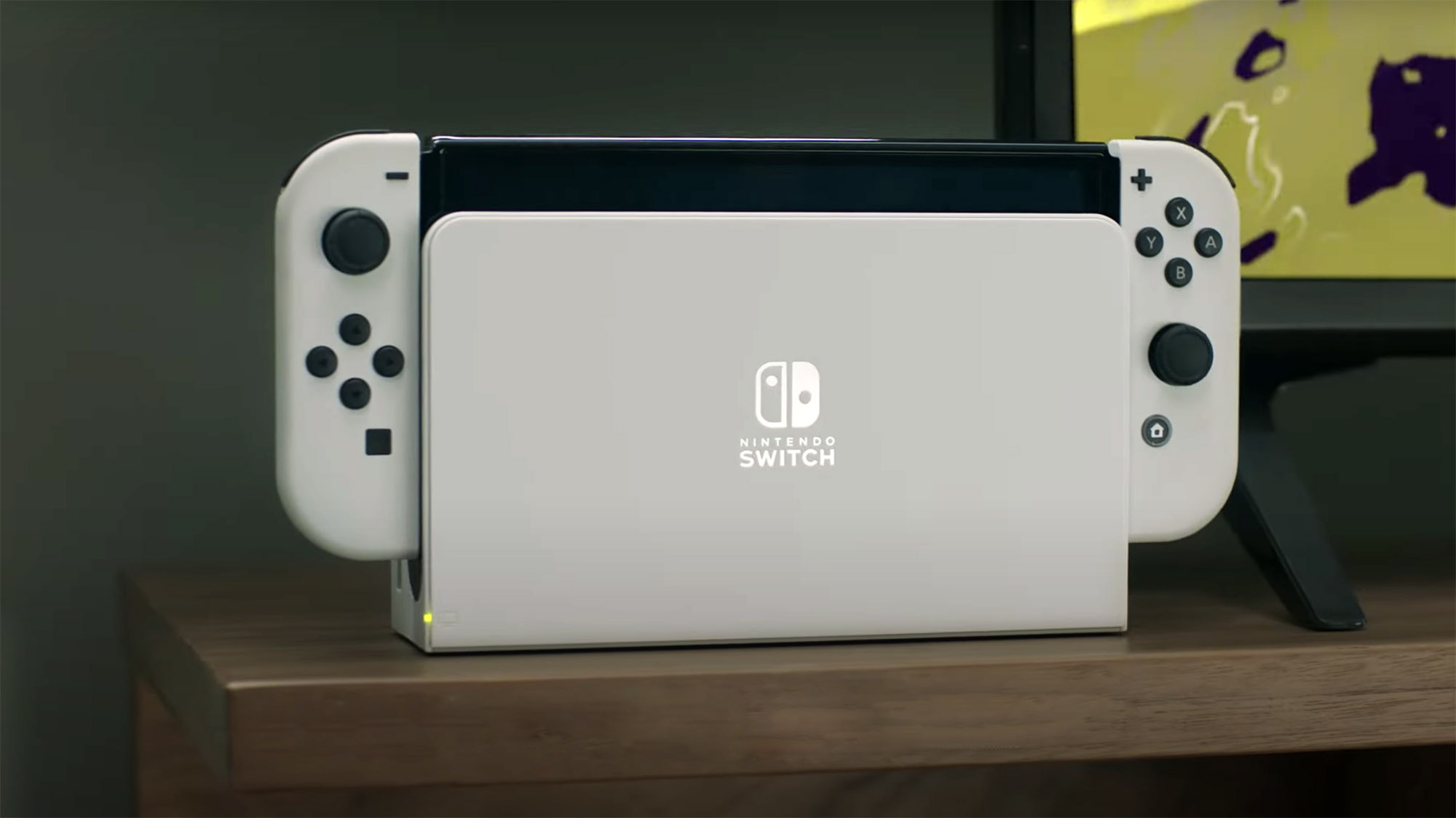Nintendo Switch OLED model handheld console displaying a vibrant game screen.