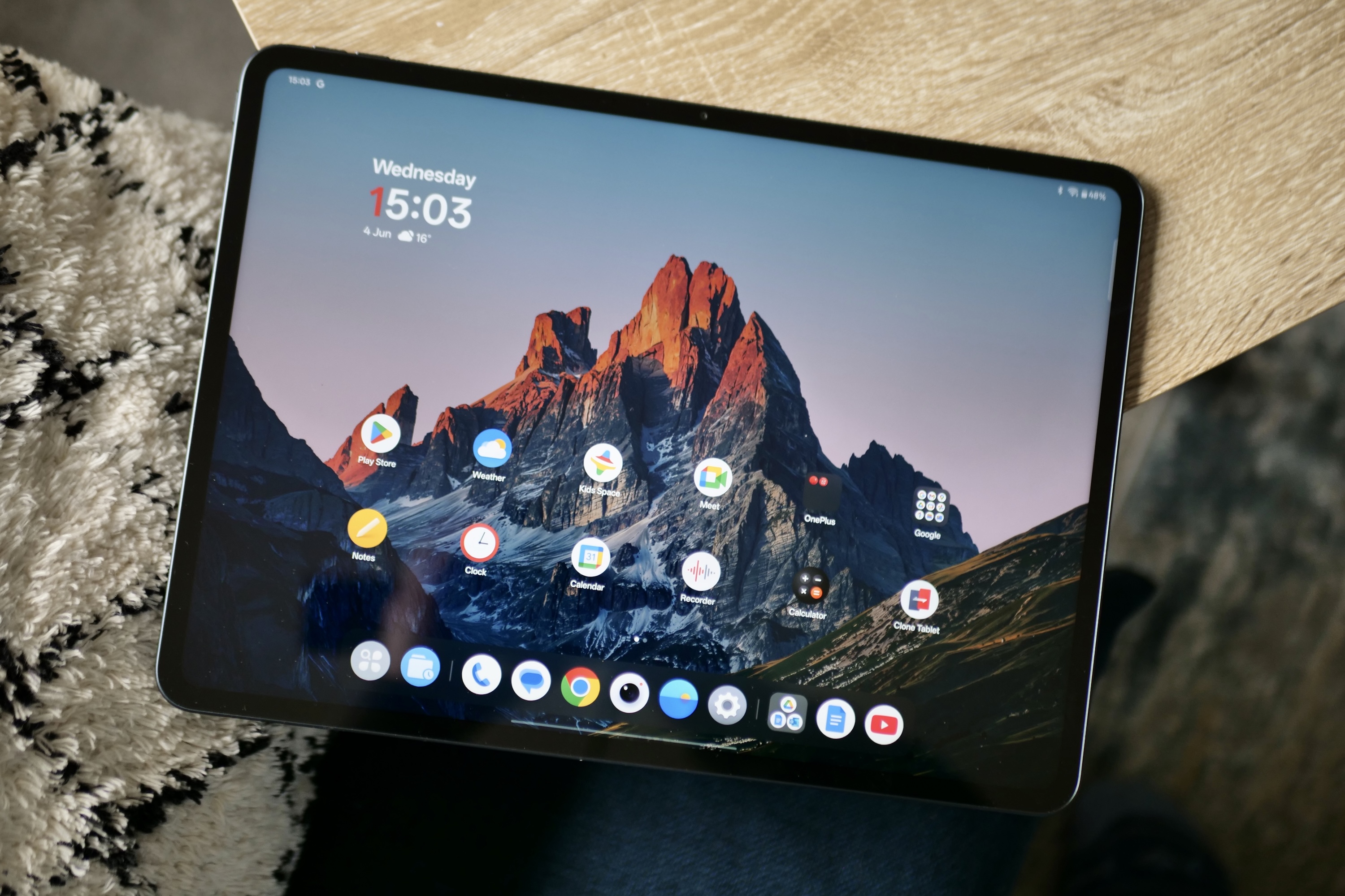 Close-up of the OnePlus Pad 3's vibrant 13.2-inch LCD screen displaying a colorful wallpaper.
