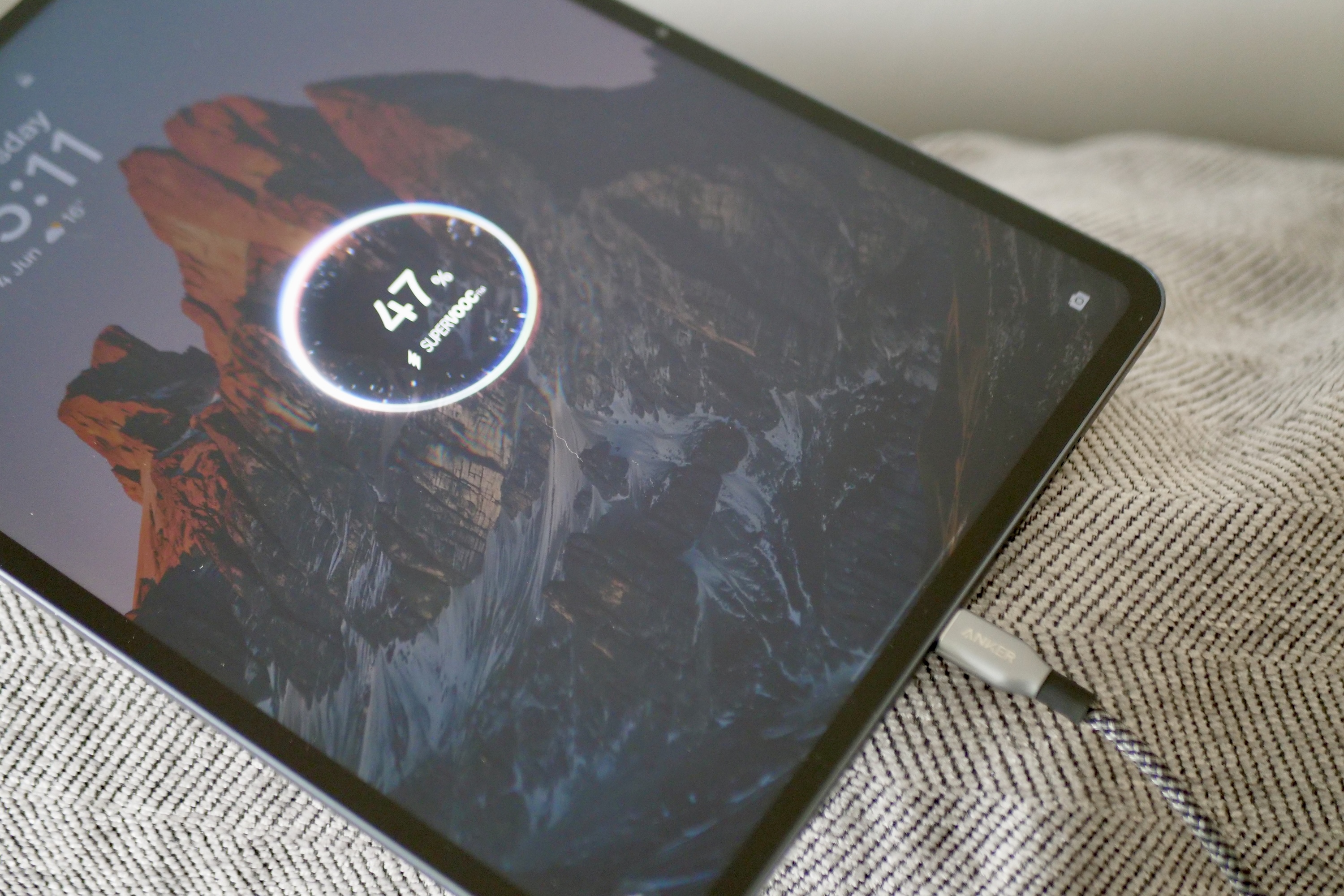 OnePlus Pad 3 connected to a USB-C charger, illustrating its 80W SuperVOOC fast charging capability.