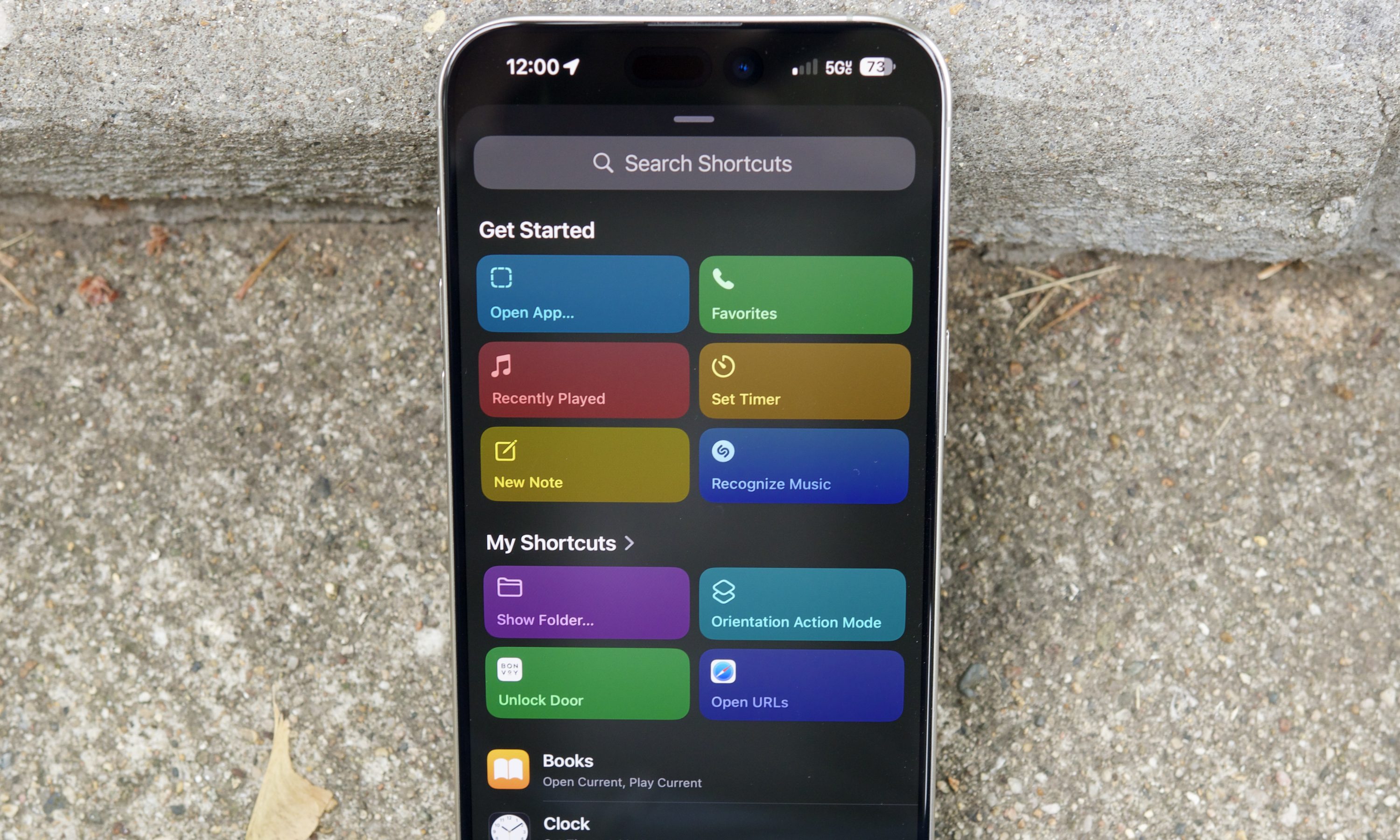 iPhone 15 Pro Max screen displaying various automation options within the iOS Shortcuts app, set for an AI upgrade in iOS 26.