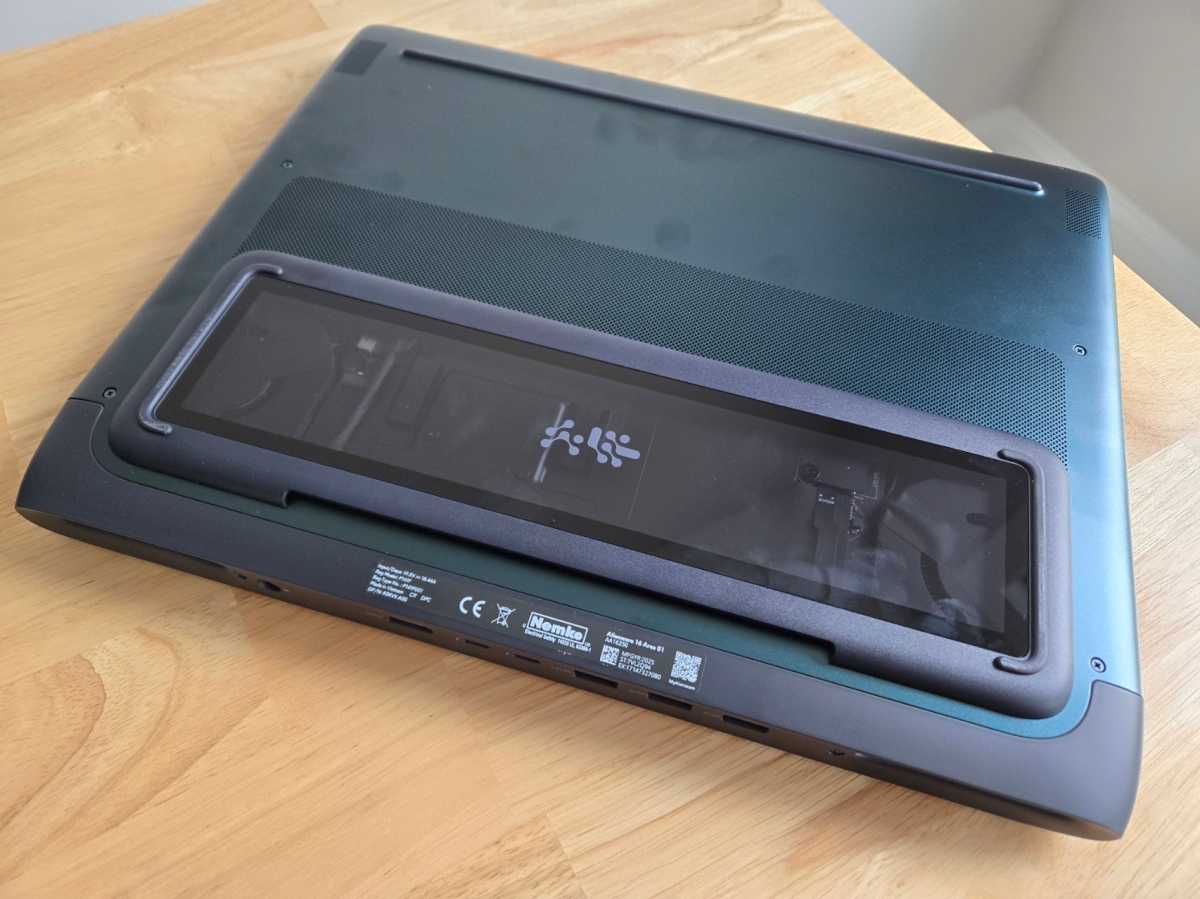 Underside of the Alienware 16 Area-51 laptop highlighting the thermal bump with Gorilla Glass for a peek inside.