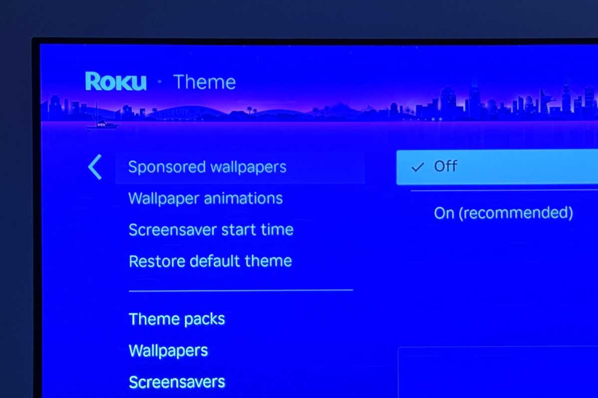 Roku theme settings menu with the 'Sponsored wallpapers' option highlighted, allowing users to disable promotional backgrounds.