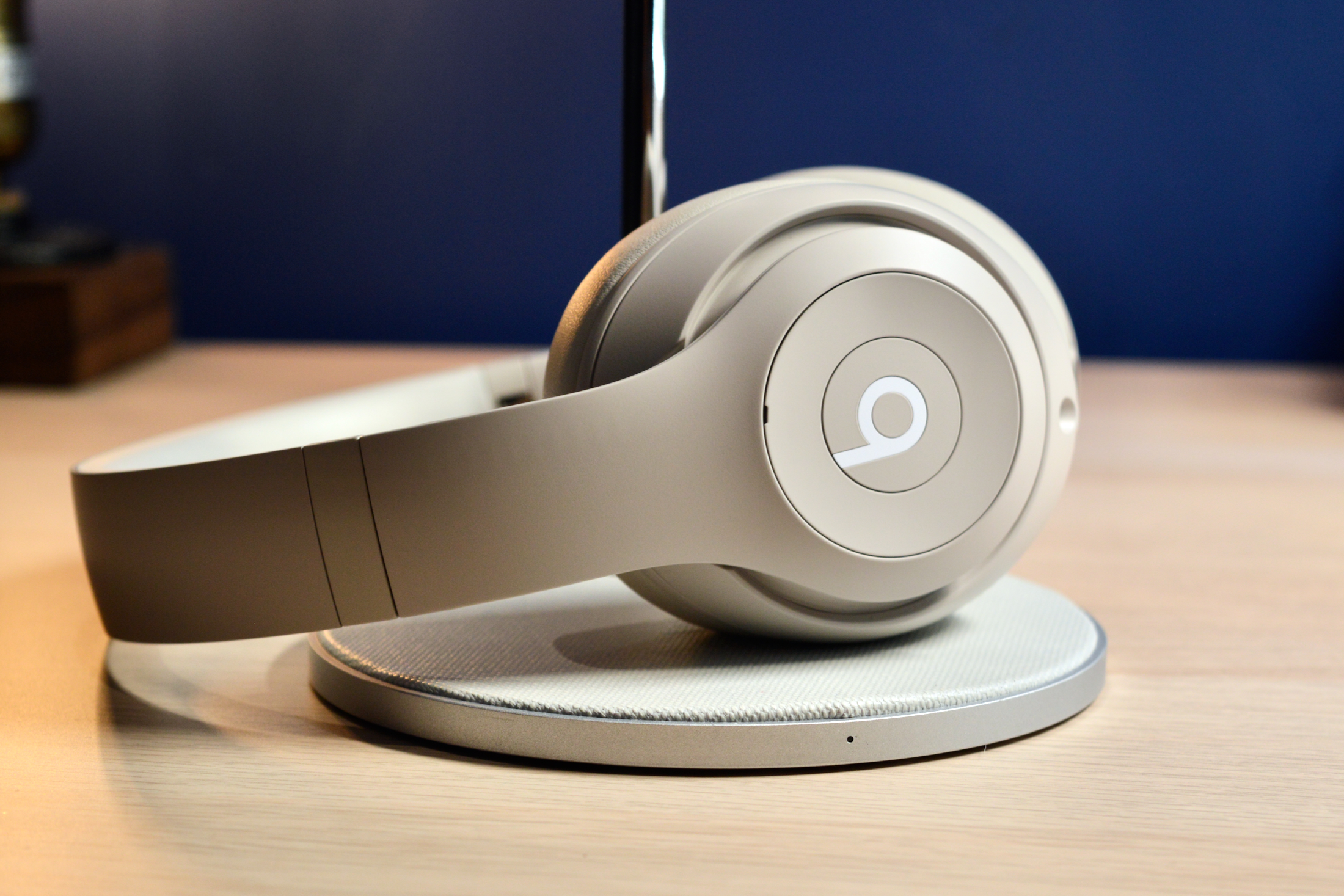 Beats Studio Pro wireless over-ear headphones in sandstone color, viewed from the side.