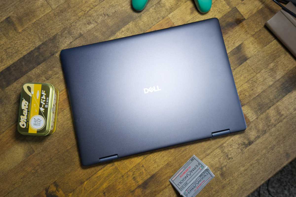 Dell Plus 14 2-in-1 laptop in silver, showcasing its slim profile and overall design.