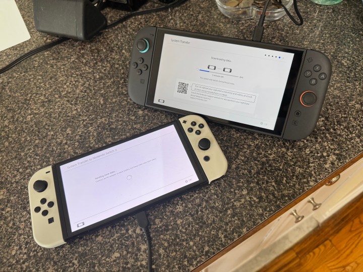 A Nintendo Switch console ready to transfer data to a new Nintendo Switch 2, highlighting the system migration process