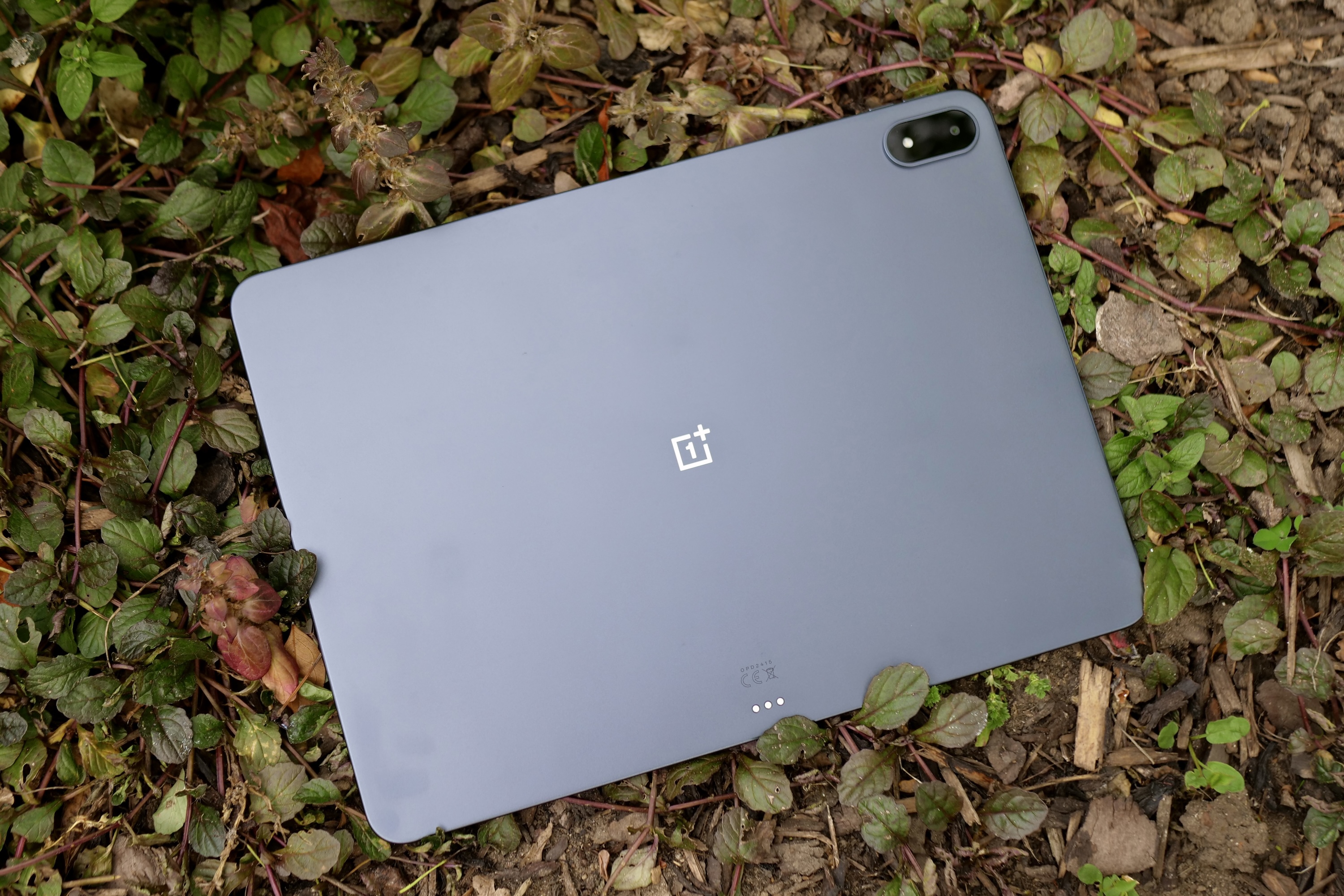 Rear view of the Storm Blue OnePlus Pad 3 showcasing its aluminum body and corner-mounted camera module.
