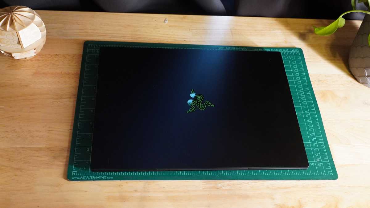 Angled view of the open Razer Blade 16 2025 gaming laptop showcasing its slim design and illuminated display.